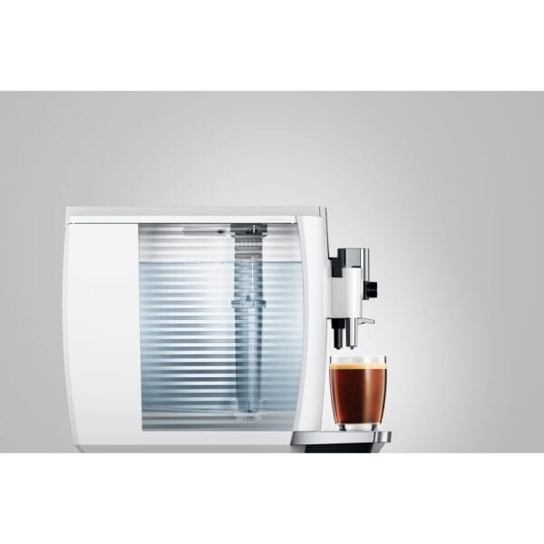 Side view of JURA E8 Piano White coffee machine showing water tank and espresso.