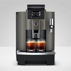 Front view of JURA W8 Dark Inox coffee machine brewing two espresso shots simultaneously.