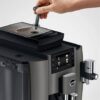 Hand adjusting the bean grinder of the JURA W8 Dark Inox automatic coffee machine – top view of professional espresso system.
