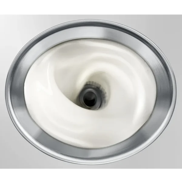 Close-up of milk being frothed inside the JURA Automatic Milk Frother stainless steel container.